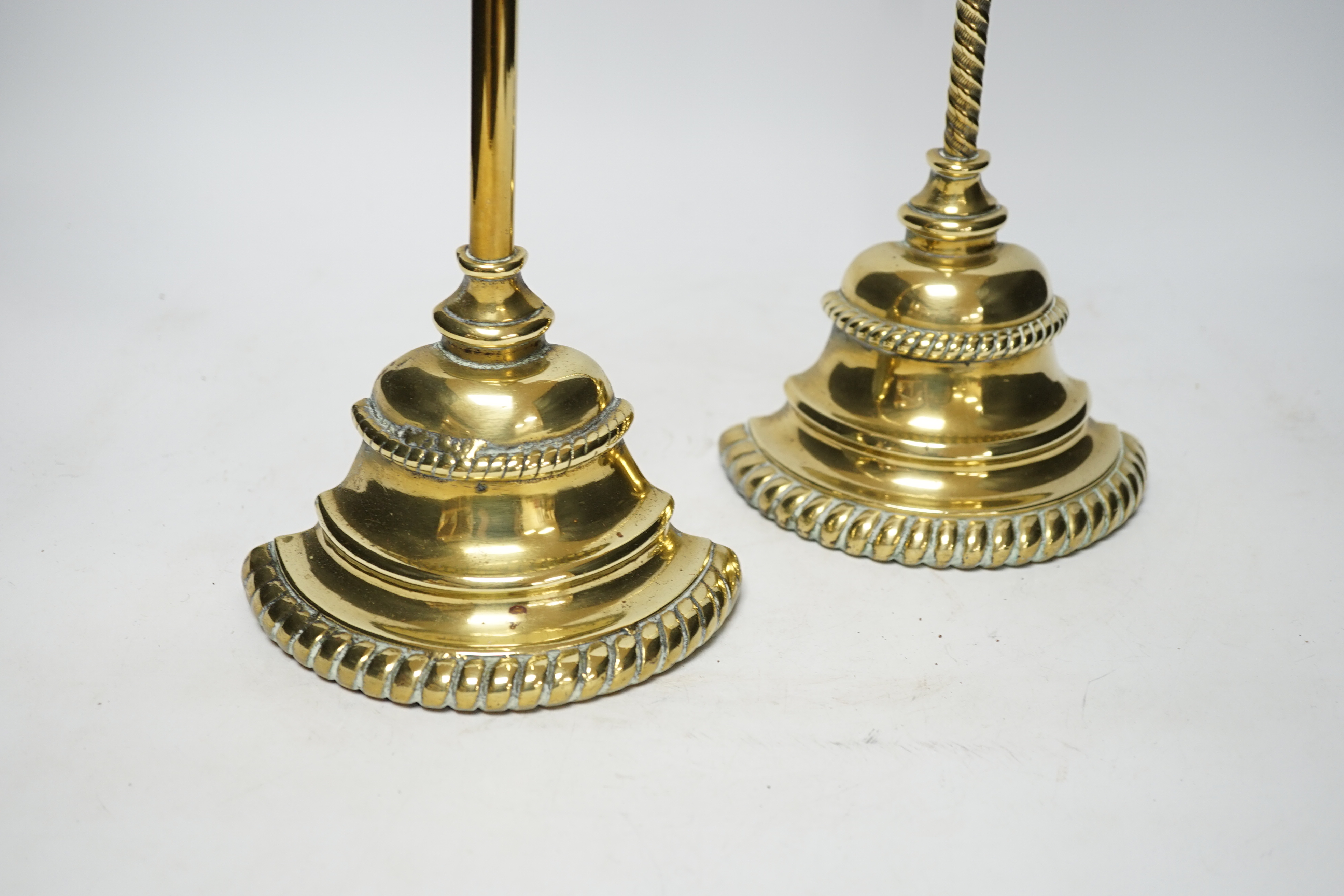 Two early 19th century cast brass door stops, with gadrooned edged plinths, tallest 50cm high